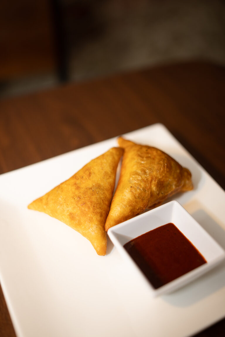 Sambusa, Light filo pastry filled with seasoned ground sirloin or lentils (2 pieces).